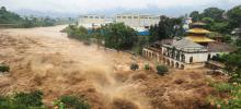 A swollen river surges through Kathmandu, Nepal's capital, after the heaviest rainfall in over 50 years.